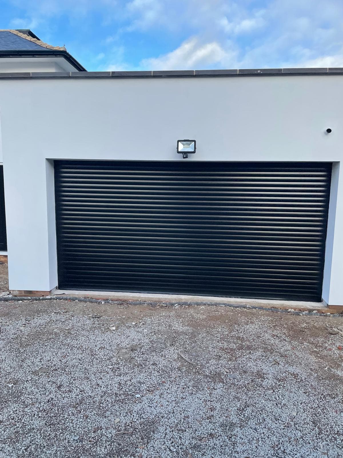 wide black garage door — installation by Complete Gate Automation